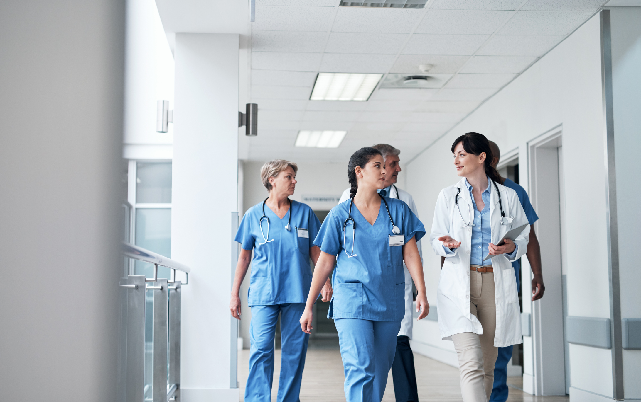 doctors and nurses walking down a hallway