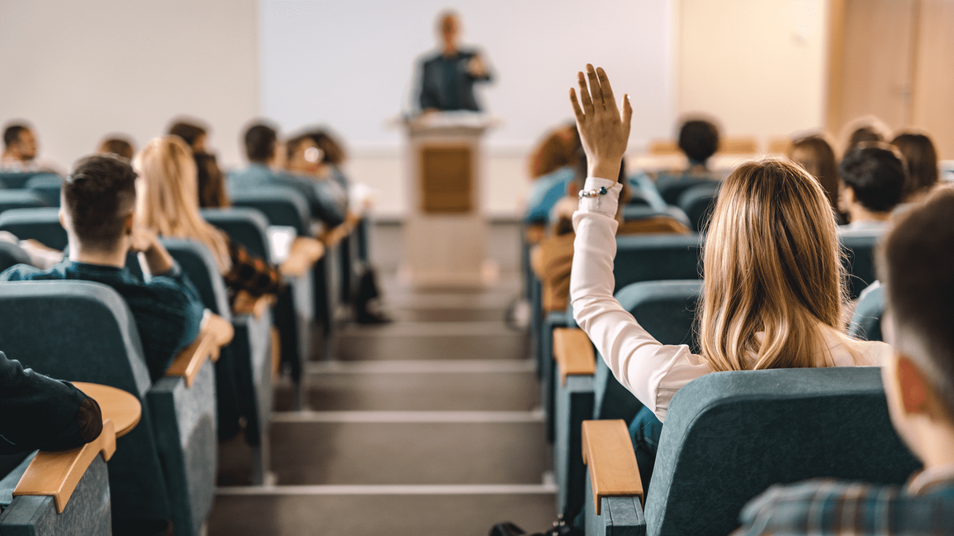 student raising her hand in class
